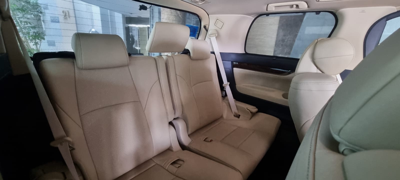 Beige leather seating inside a luxury MPV chauffeur vehicle in Singapore